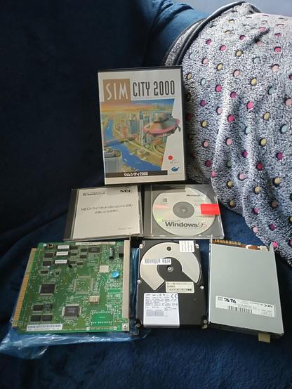 Pile of PC9821 related parts inc. HDD, FDD, CBus network card, various CD's and a boxed copy of SimCity 2000