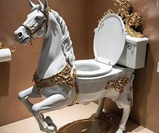 A toilet designed to resemble a white horse with gold decorations.
