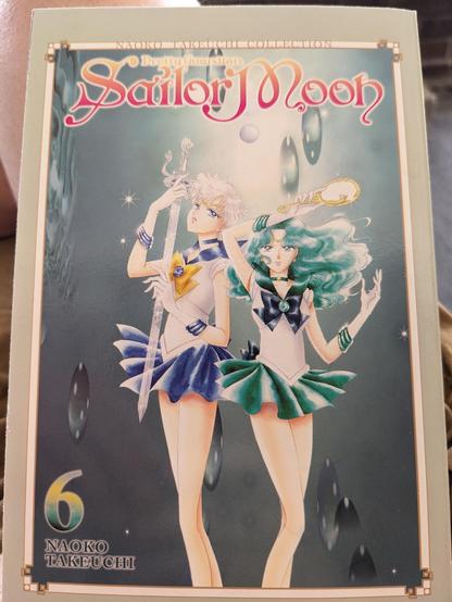 The cover of Volume 6 of the SAILOR MOON manga, depicting Sailors Uranus and Neptune holding their talismans, the Space Sword and Deep Aqua Mirror