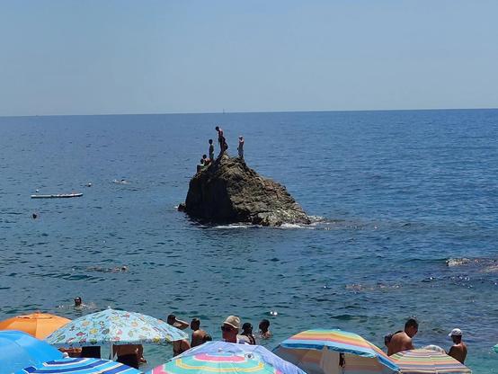 People plunging into the sea from a rock