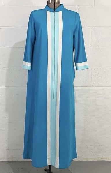 1970s Teal blue Vanity Fair robe with white and aqua vertical stripes on the front and white and aqua accents on the sleeve cuffs, displayed on a mannequin against a white brick wall.