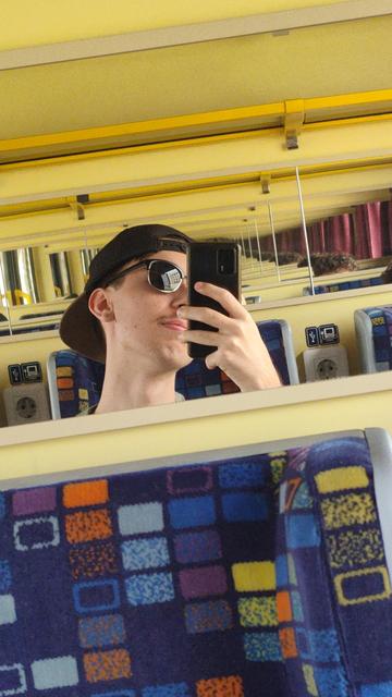 picture of me in the train with sunglasses and hat