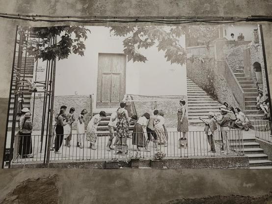 A drawing on the wall showing people playing in Corniglia dressed like in the 50's