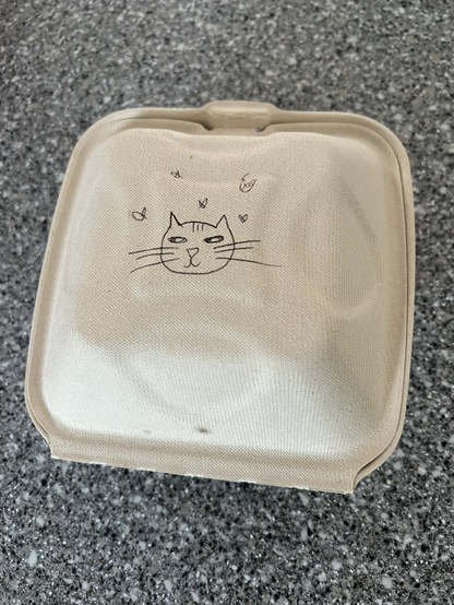 Fast food container with a kitty drawn on it. 