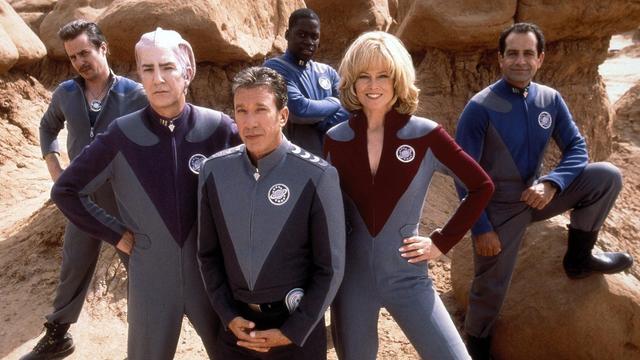 The cast of Galaxy Quest wearing their super cool jumpsuits in super cool hero poses