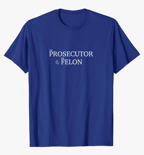 A blue tshirt that has the text, “The Prosecutor vs The Felon”