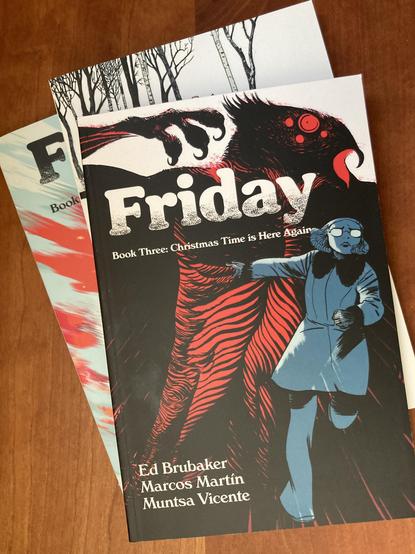 Photo of the three volumes of the comic Friday by Ed Brubaker, Marcos Martin, and Muntsa Vicente.