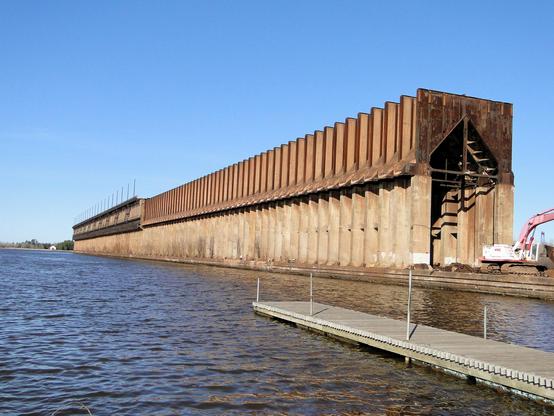 Abandoned Lower Harbor Iron Ore Dock.  A series of concrete and steel columns form a huge tunnel, beside Lake Superior