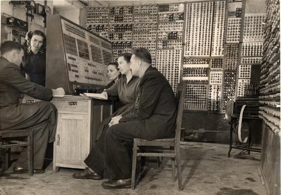 MESM, the first electronic digital computer in the Soviet Union and continental Europe, early 1950s, Lots of mechanical switches, dials and knobs. Five people including three women work the controls. 