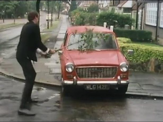 Basil Fawlty giving his car a damn good thrashing