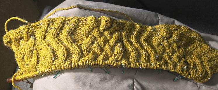 Mustard yellow cabled capelet, in progress.