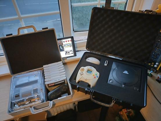 Interior view of 2 plastic cases containing SNES and Dreamcast respectively, foam lined for protection