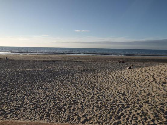 The beach and a sea still far away while the tide is rising