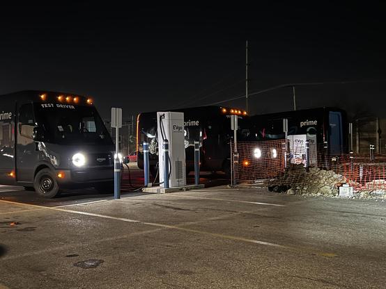 Amazon Rivian EV trucks, recharging at night