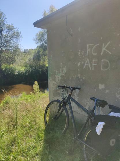 An einem Trafohäuschen steht mit weißer Farbe 