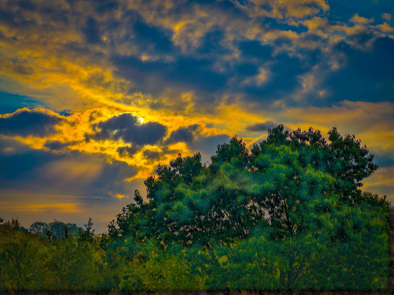 Sunshine behind a cloudy sky in the morning.