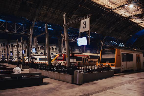 The interior of Estació de França at night. Under the metal structure, there are two Renfe class 450 double-decker trains, as well as two Civia trains, and several Renfe class 448 and 449 medium-distance trains.