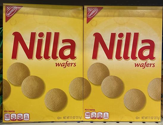 Two Nilla wafers boxes next to each other. The edge of the wafer design on the front matches up perfectly so the boxes next to each other make a longer wafer line.