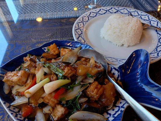 Pad eggplant tofu vegetable stir fry in a blue fish-shaped dish at Bahn Thai in downtown Fairbanks Alaska.