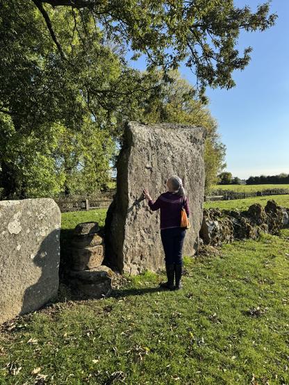 Natacha touching a large stone in the Grange Stone Circle, Éire