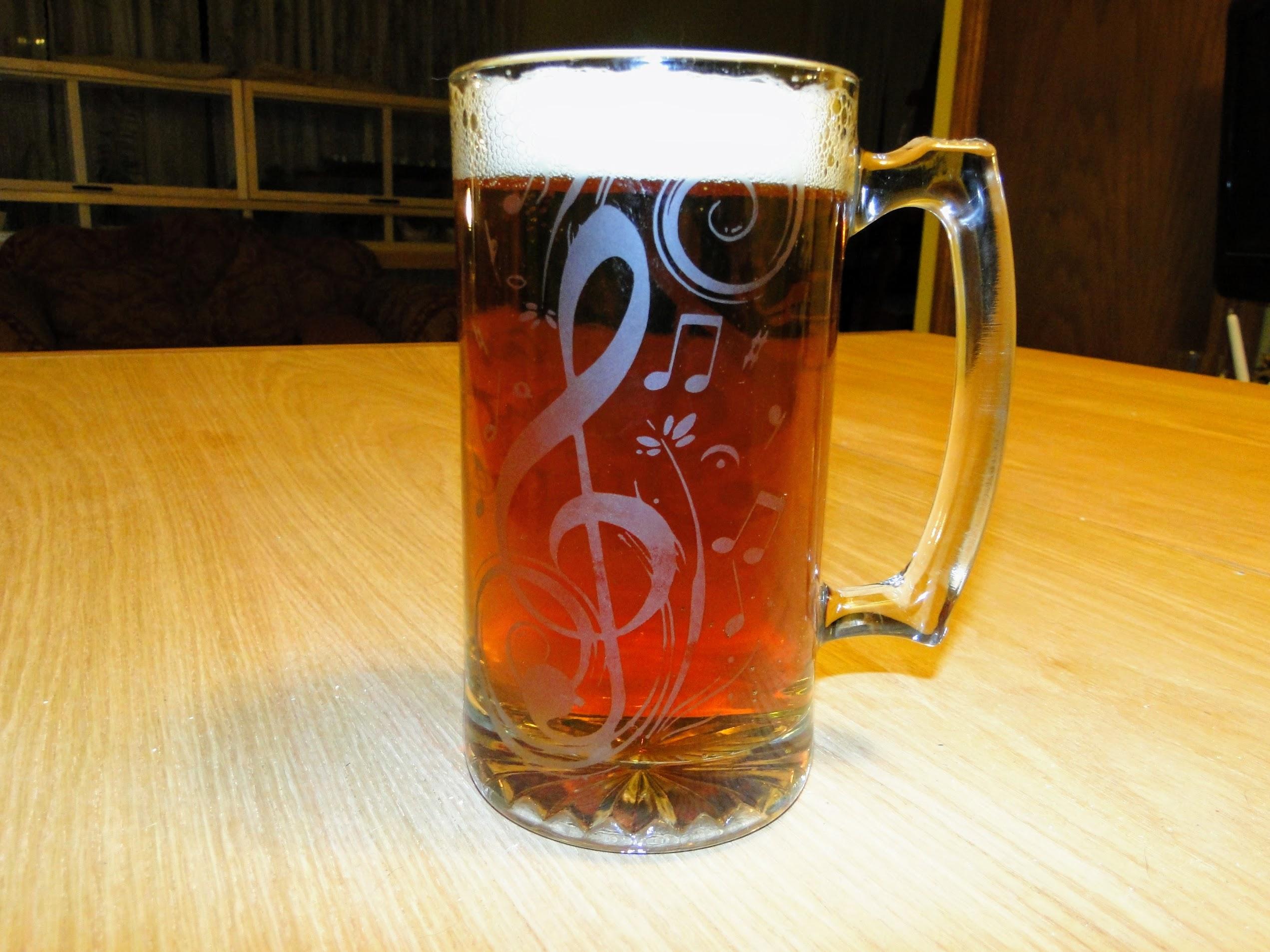 A large glass beer mug the Germans call a Litermass - though this is rather bigger than a liter. ( It holds exactly two Hacker-Pschorr bottles ) It has been masked and sandblasted by my lovely wife, whose kindness and insight is a marvel. This is the side <br />with the treble clef and other musical symbols.