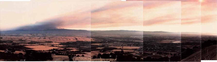 A stitched panorama of the 1985 Lexington Fire in the Santa Cruz Mountains, looking west-south-west, taken from an elevation of about 2000 feet in the foothills on the opposite of the Santa Clara Valley in southeast San Jose, off Quimby Road, taken in the late afternoon.

The lower half of the photos shows the Santa Clara Valley and the Santa Cruz mountains, the upper half shows smoke from the fire on the left (south end) of the photos, blowing "up and to the right" in the wind.  The left foreg…