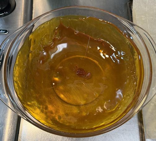 A pyrex bowl coated with caramel.