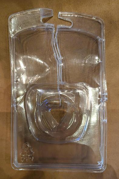 Empty plastic product packaging, the kind that is welded shut.  It is torn open from the top all the way down to the product bulge.